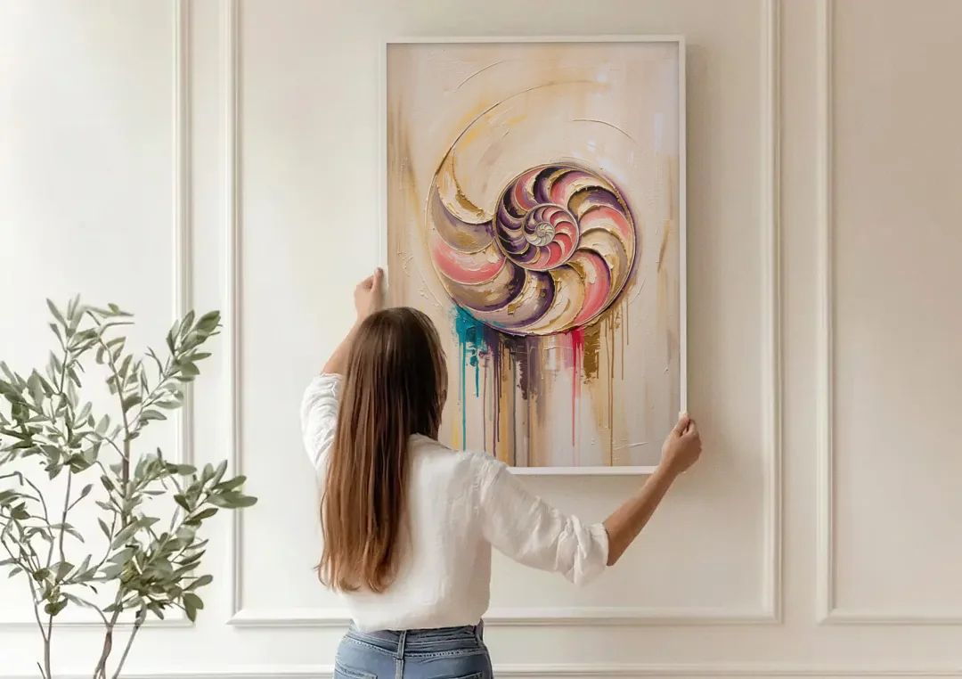 Nautilus Spiral in Blush and Gold canvas wall art being hung on a paneled wall