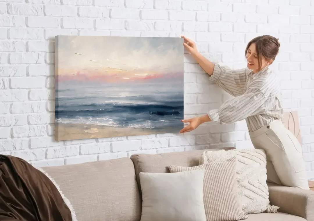 Neutral Abstract Painting of a Blush Horizon canvas wall art being hung on a white brick wall above a sofa
