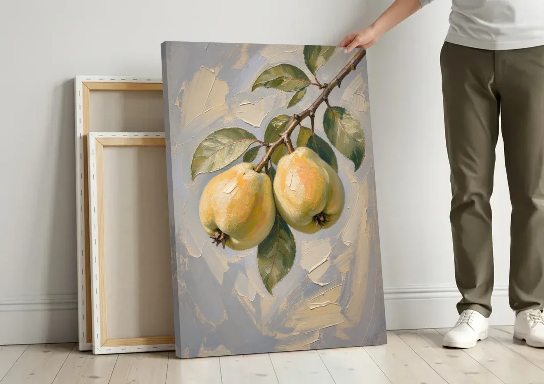 Neutral Botanical Wall Art of a Quince Branch canvas wall art leaning against a wall next to blank canvases