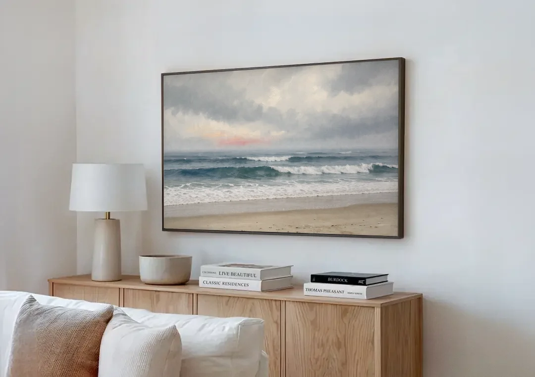 Neutral Coastal Pink Glow Over Gray Surf canvas wall art above a wooden sideboard next to a sofa
