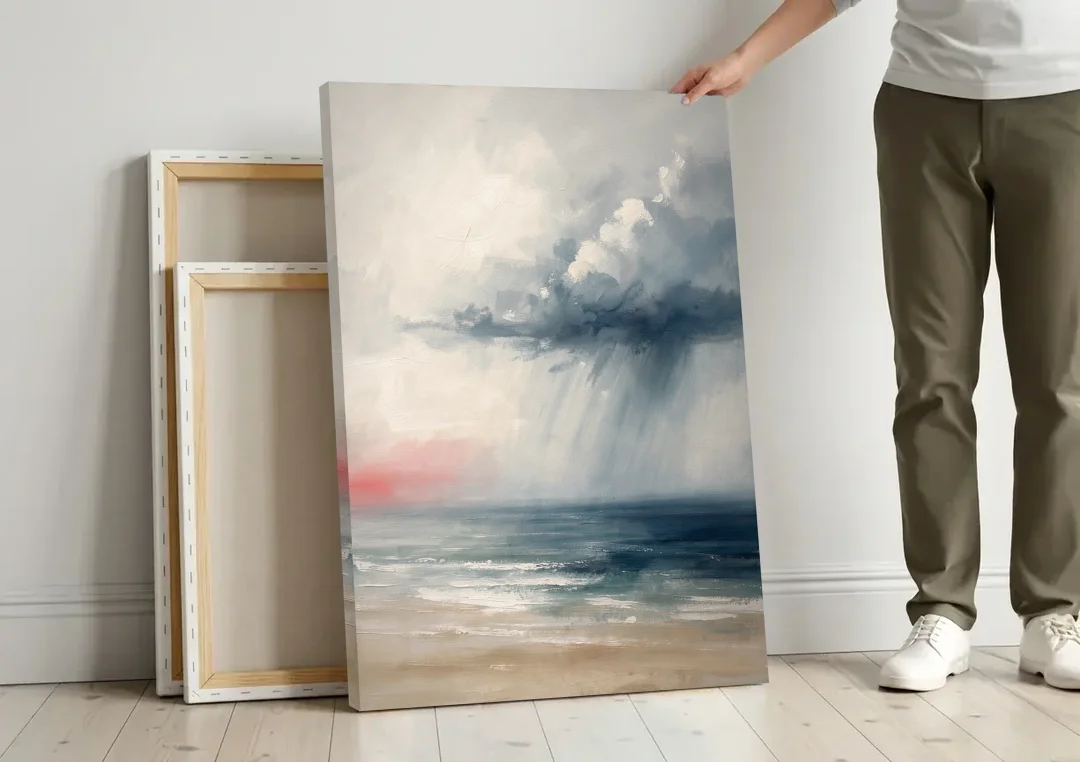 Neutral Distant Rain Squall Over a Calm Sea canvas wall art leaning against a wall next to blank canvases