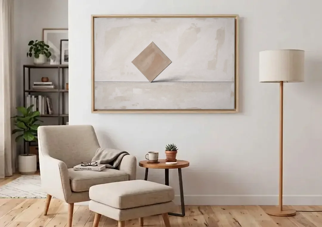 Neutral Modern Wall Art of a Balancing Square canvas wall art above an armchair in a bright living room