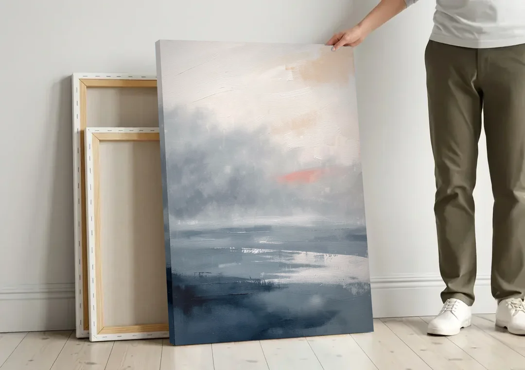 Neutral Sea Fog on Calm Water canvas wall art leaning against a wall next to blank canvases