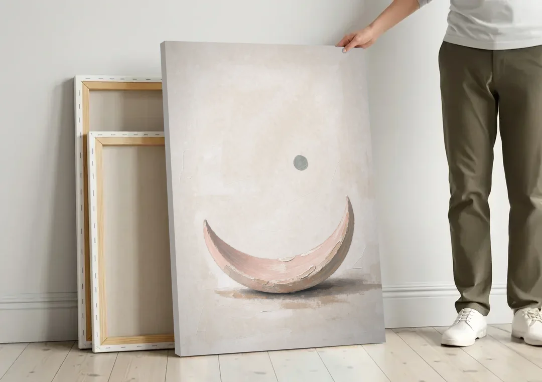 Neutral Wall Art for Bedroom with Blush Crescent Cradle canvas wall art leaning against a wall next to blank canvases