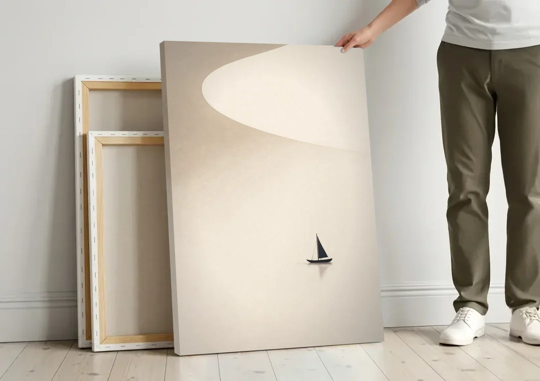 Neutral Wall Art of a Becalmed Sailboat canvas wall art leaning against a wall next to blank canvases