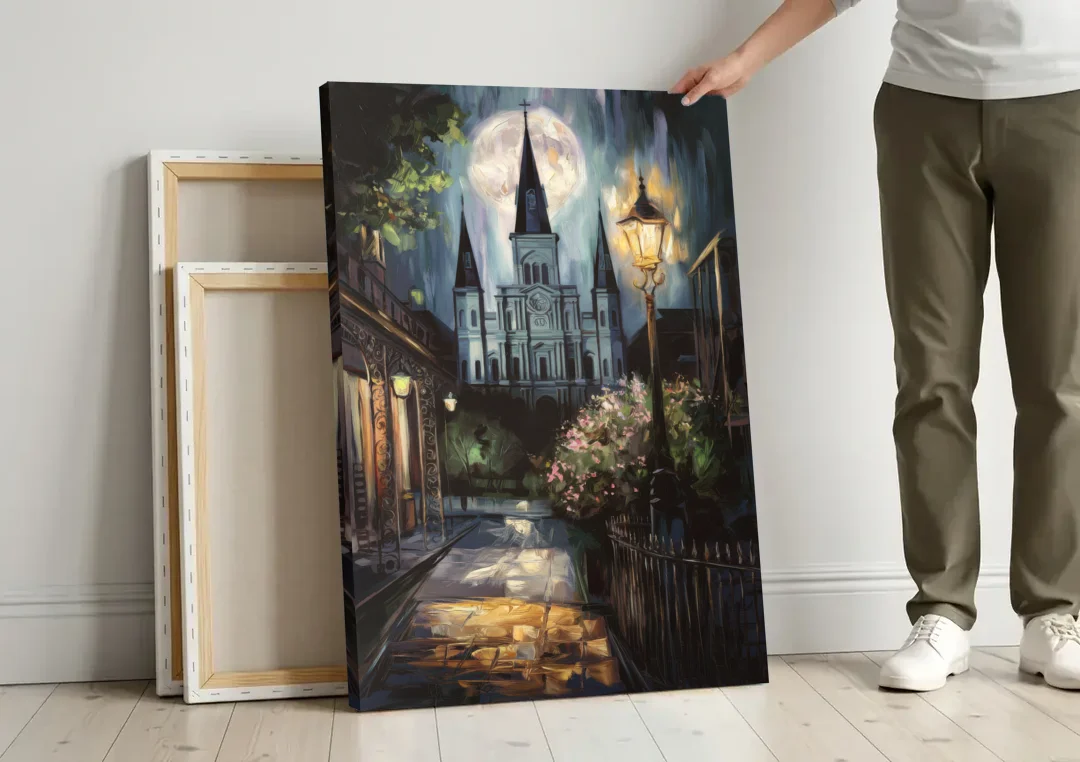 New Orleans Cathedral Silhouette canvas wall art leaning against a wall next to blank canvases