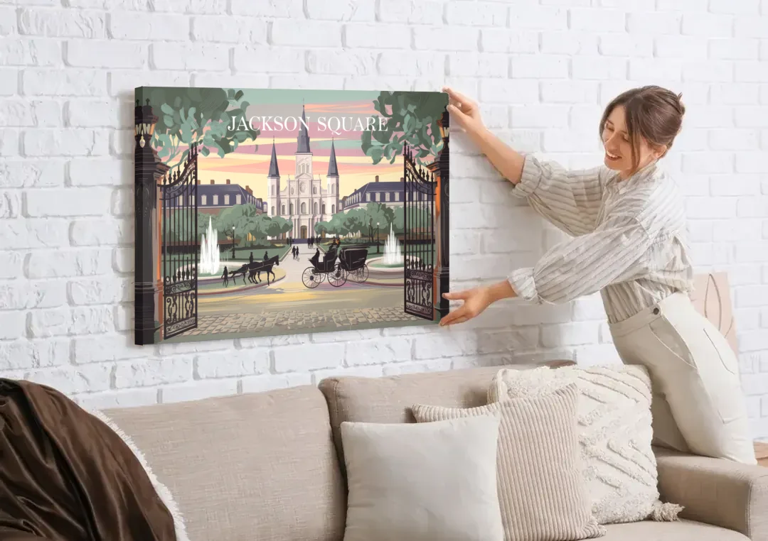 New Orleans Jackson Square canvas wall art being hung on a white brick wall above a sofa