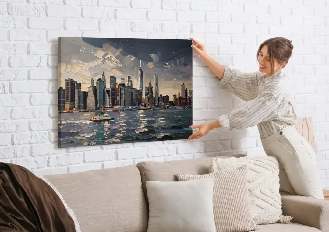 New York City Black And White Skyline canvas wall art being hung on a white brick wall above a sofa