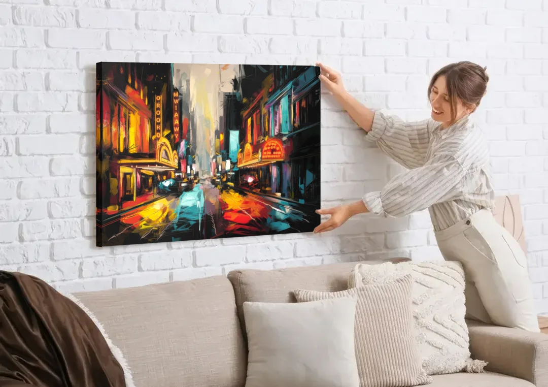 New York City Broadway Lights canvas wall art being hung on a white brick wall above a sofa