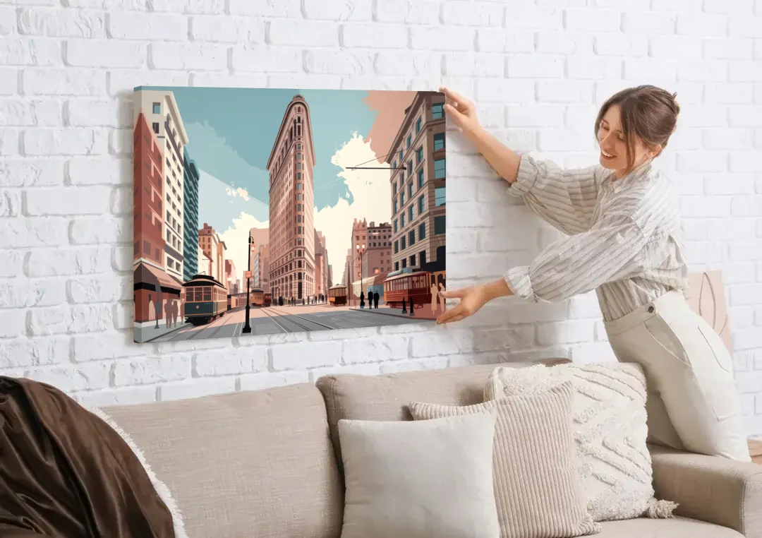 New York City Flatiron Building canvas wall art being hung on a white brick wall above a sofa