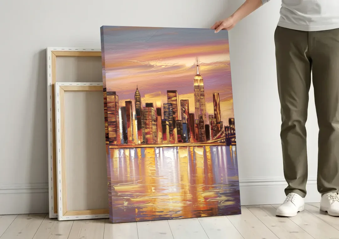 New York City Skyline at Dusk canvas wall art leaning against a wall next to blank canvases