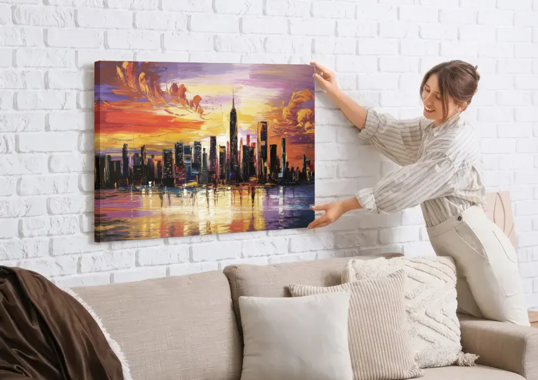 New York City Skyline At Sunset canvas wall art being hung on a white brick wall above a sofa