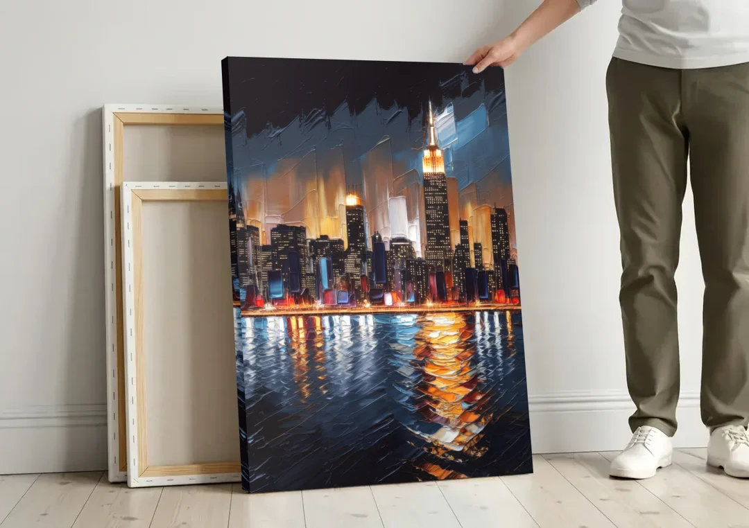 New York City Skyline by Nightfall Hudson canvas wall art leaning against a wall next to blank canvases