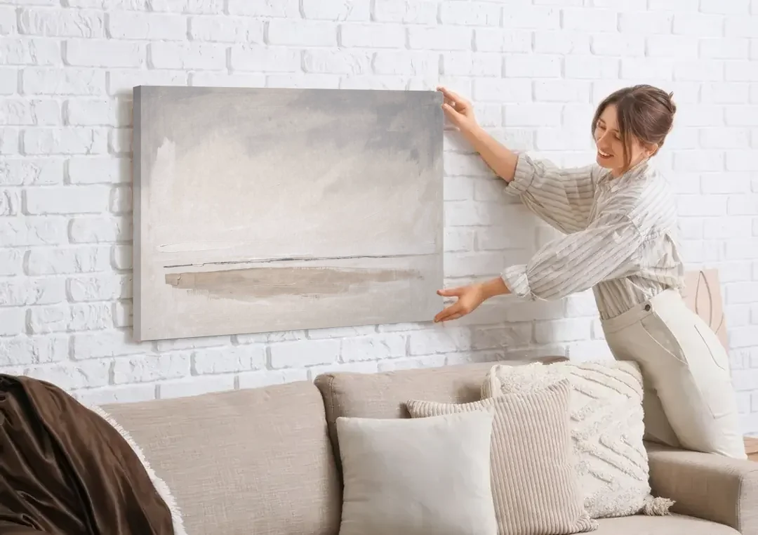 Nordic Wall Art Driftwood Band Under Sea Fog canvas wall art being hung on a white brick wall above a sofa
