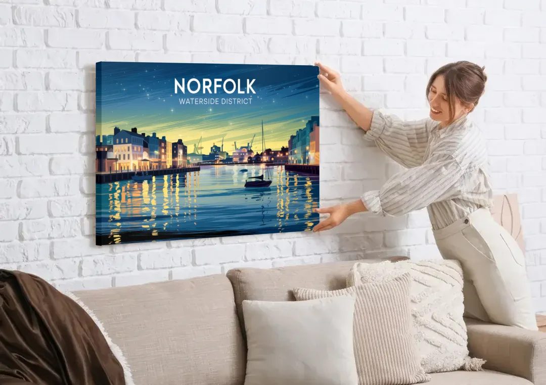 Norfolk Waterside District canvas wall art being hung on a white brick wall above a sofa