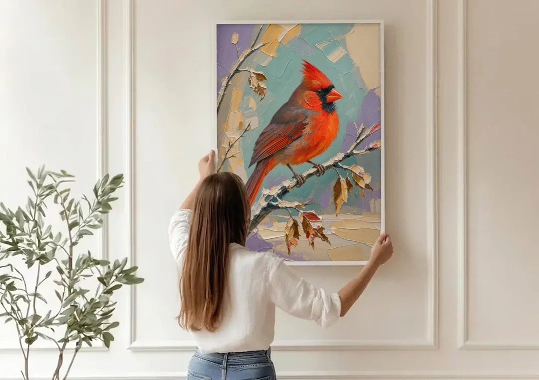 Northern Cardinal on a Snowy Branch canvas wall art being hung on a paneled wall