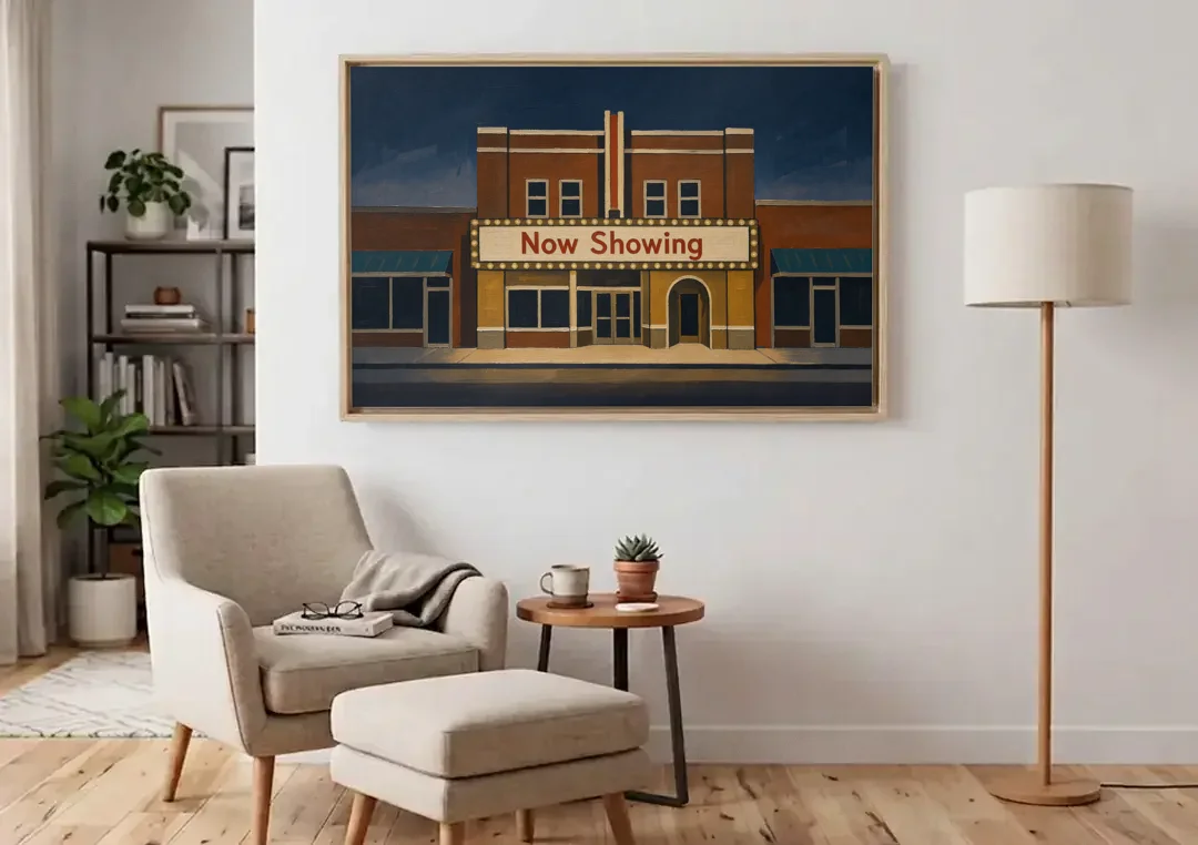 Now Showing Small Town Movie Theater at Dusk canvas wall art above an armchair in a bright living room