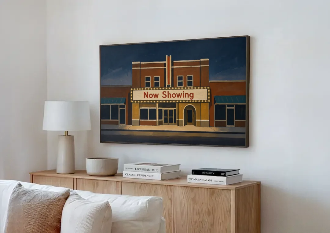 Now Showing Small Town Movie Theater at Dusk canvas wall art above a wooden sideboard next to a sofa