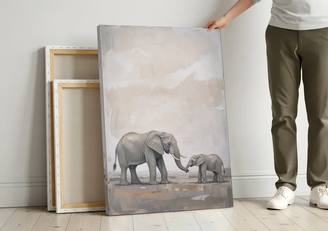 Nursery Wall Decor Above Crib with Elephant Trunks Touching canvas wall art leaning against a wall next to blank canvases
