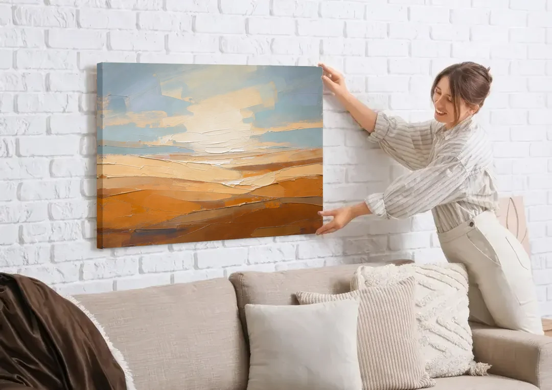 Ochre Desert Horizon at First Light canvas wall art being hung on a white brick wall above a sofa