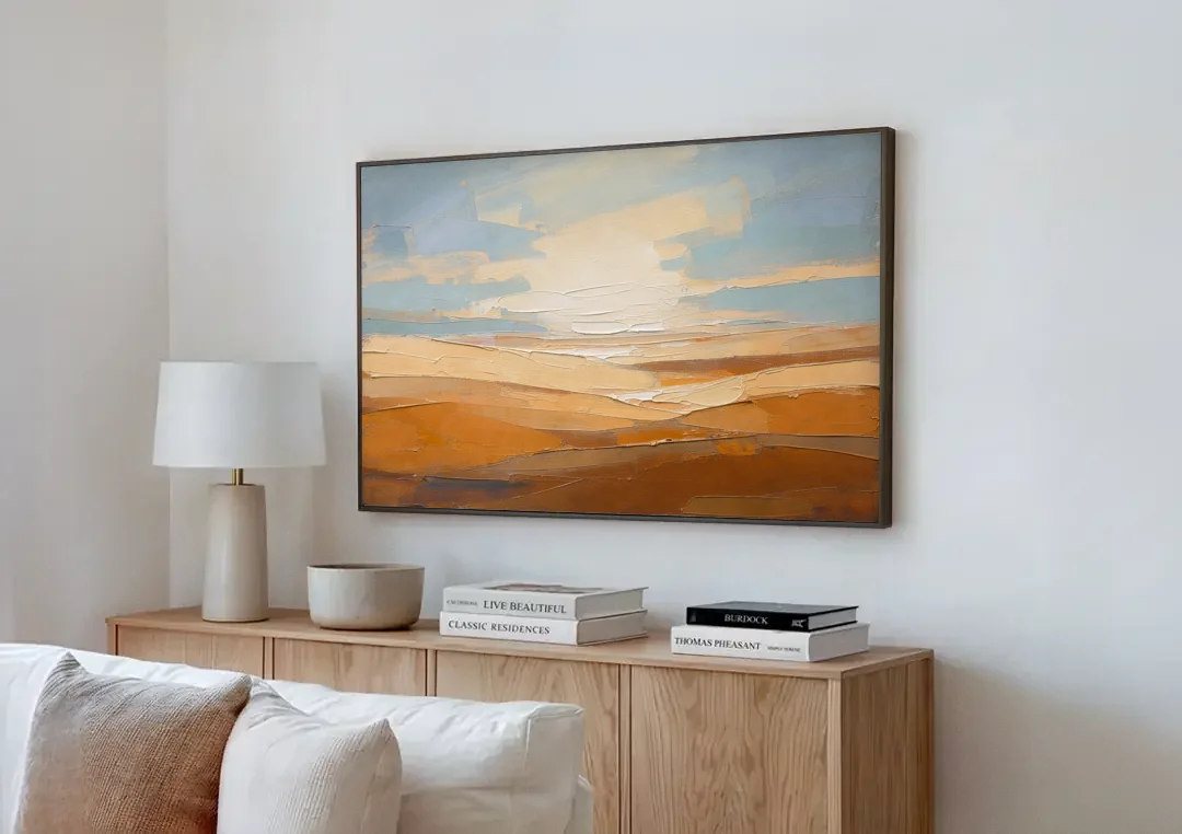 Ochre Desert Horizon at First Light canvas wall art above a wooden sideboard next to a sofa