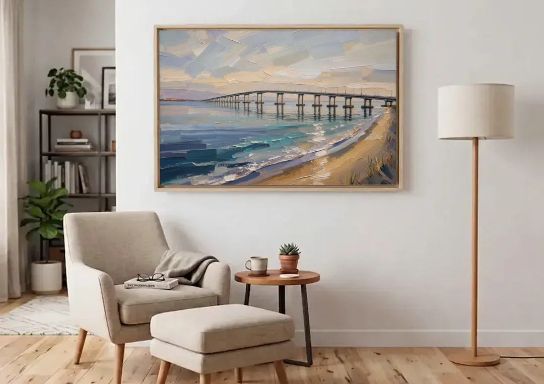 Office Canvas Wall Art of a Long Bay Bridge canvas wall art above an armchair in a bright living room