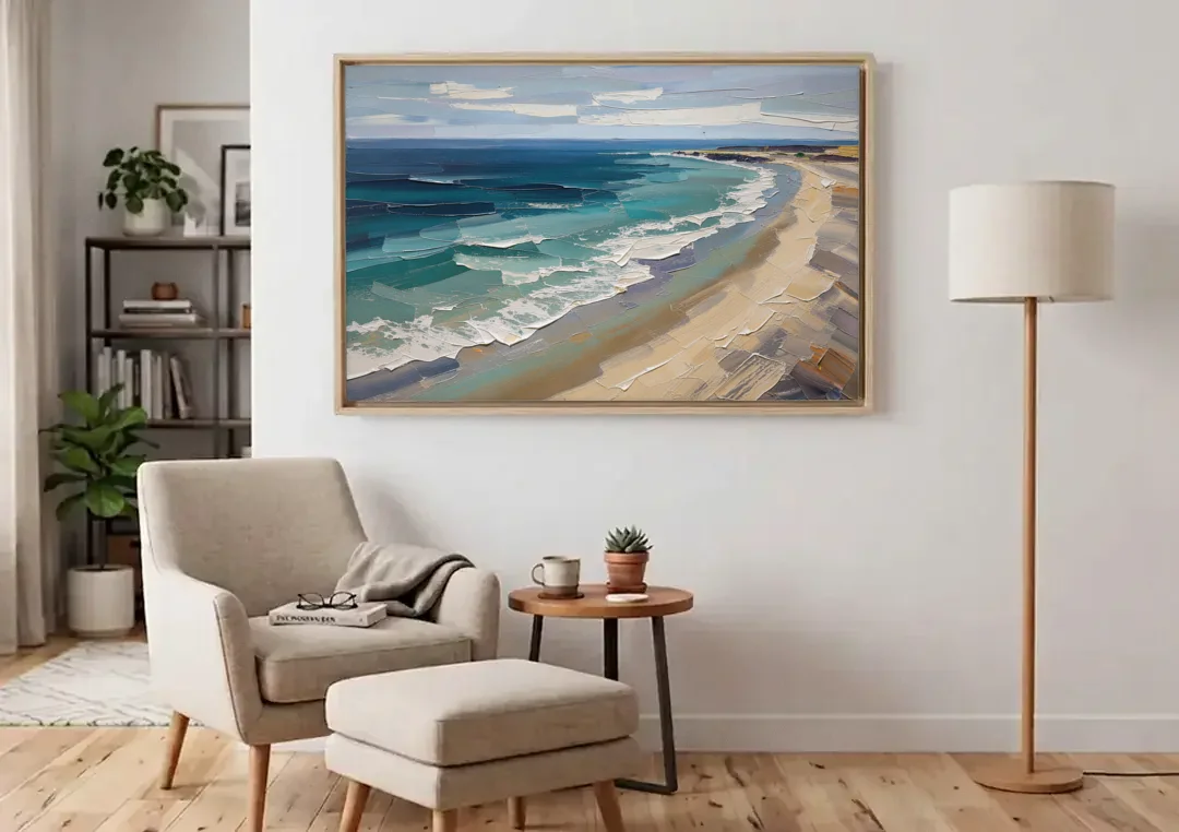 Office Wall Decor with Surf Curving Along Sand canvas wall art above an armchair in a bright living room