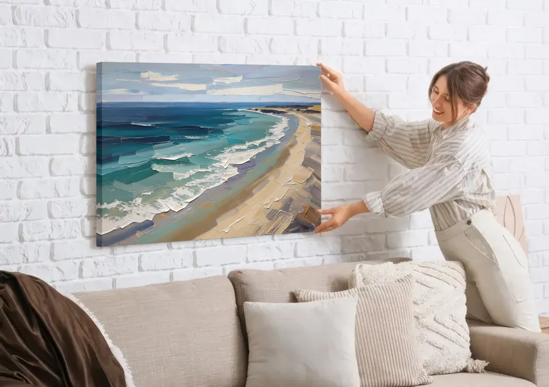 Office Wall Decor with Surf Curving Along Sand canvas wall art being hung on a white brick wall above a sofa