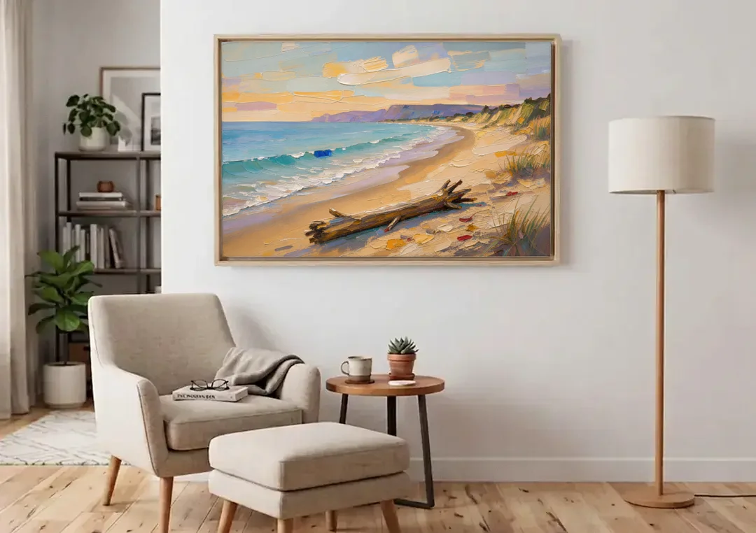 Oil Painting of Beach and Lone Driftwood canvas wall art above an armchair in a bright living room