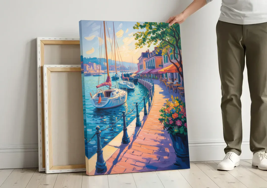 Old Port Waterfront canvas wall art leaning against a wall next to blank canvases