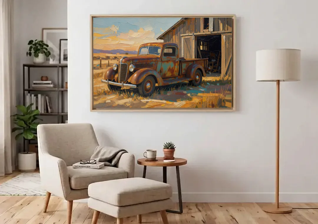 Old Truck Painting by the Weathered Barn canvas wall art above an armchair in a bright living room
