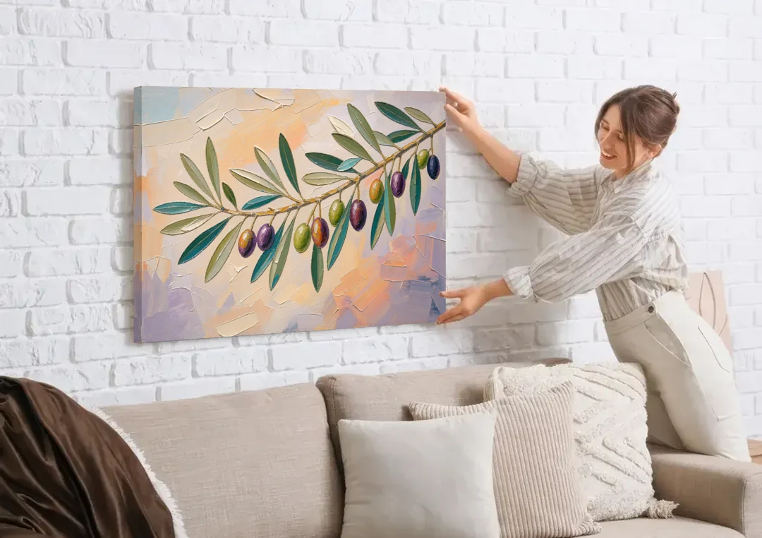 Olive Branch Painting in Pastel Light canvas wall art being hung on a white brick wall above a sofa