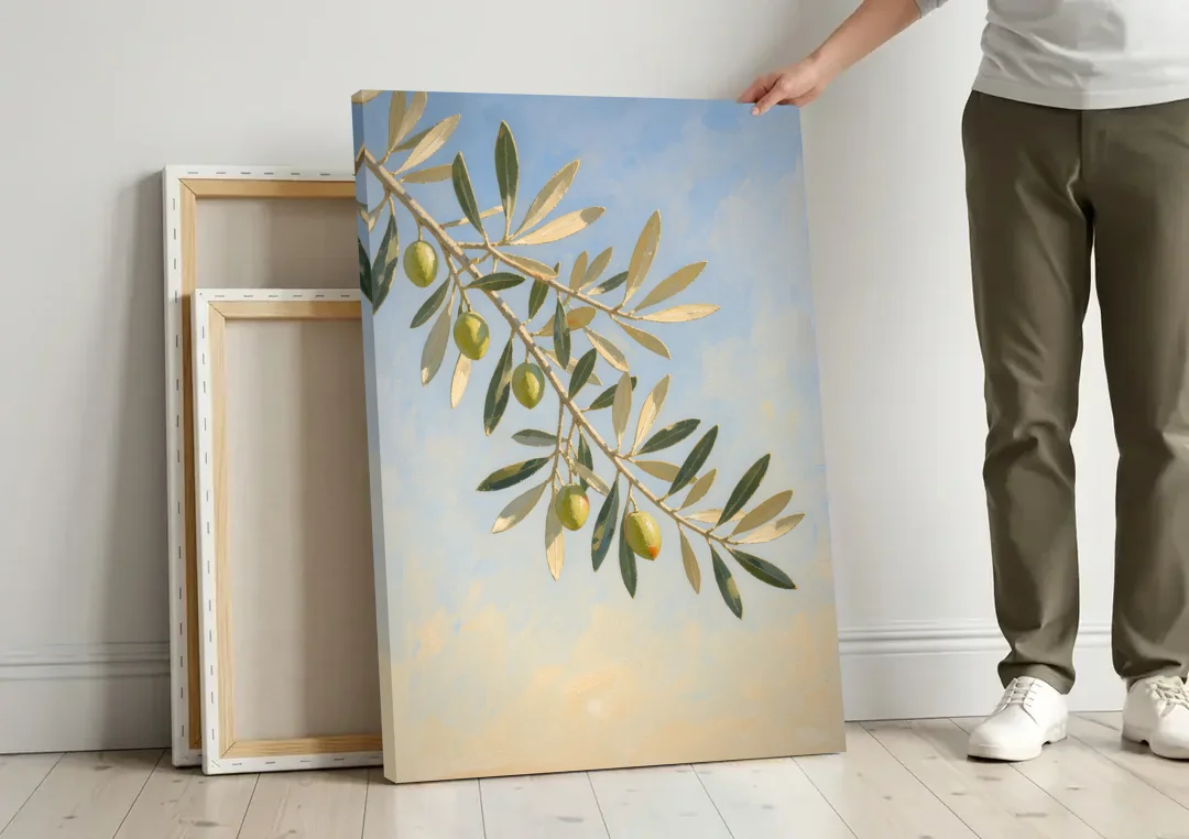 Olive Branch Under Sunny Sky for the Kitchen canvas wall art leaning against a wall next to blank canvases