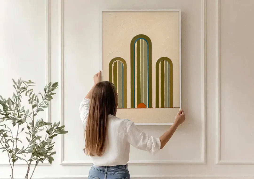 Olive Green Wall Art with Three Striped Arches canvas wall art being hung on a paneled wall