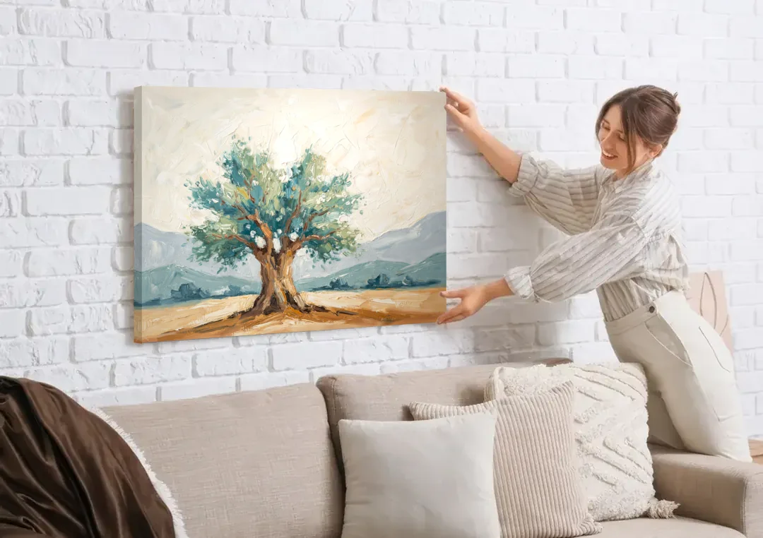 Olive Tree Painting on a Sunlit Terrace canvas wall art being hung on a white brick wall above a sofa