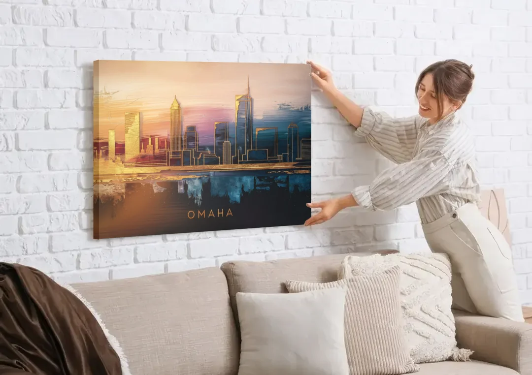 Omaha City Skyline canvas wall art being hung on a white brick wall above a sofa