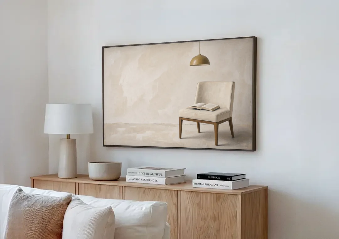 Open Book Painting on a Cream Side Chair canvas wall art above a wooden sideboard next to a sofa