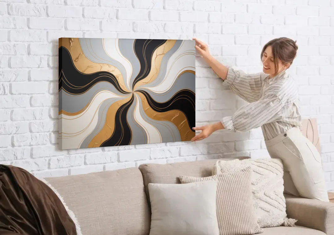 Opulent Geometry Black White and Gold Abstract canvas wall art being hung on a white brick wall above a sofa
