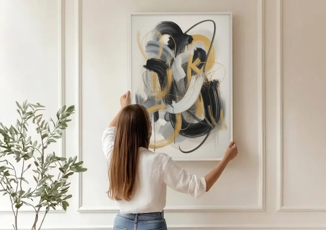 Opulent Movement Black White and Gold Abstract canvas wall art being hung on a paneled wall