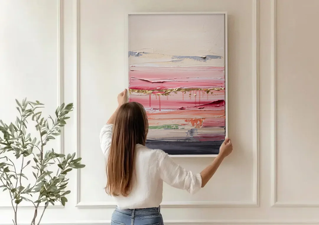 Opulent Serenity Pink and Gold Abstract canvas wall art being hung on a paneled wall