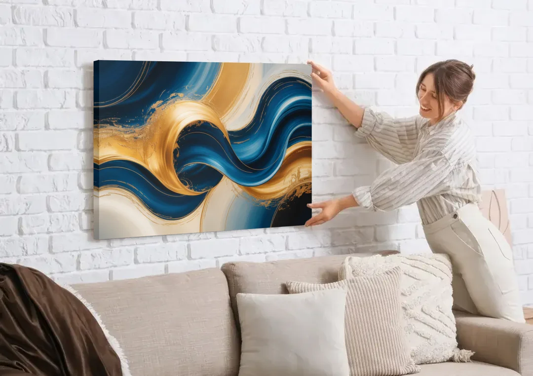 Opulent Waves in Blue and Gold Abstract canvas wall art being hung on a white brick wall above a sofa