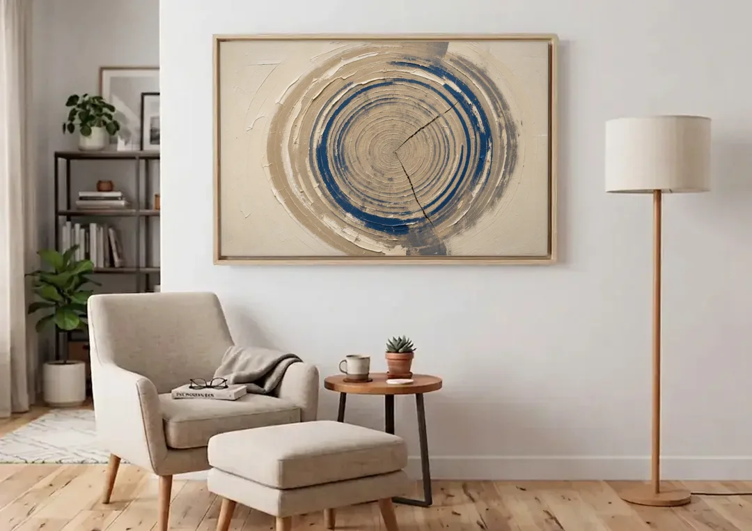 Organic Abstract Wall Art of Navy Tree Rings canvas wall art above an armchair in a bright living room