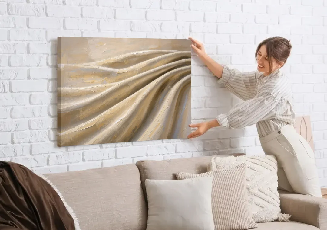 Organic Modern Wall Art of Draped Linen Folds canvas wall art being hung on a white brick wall above a sofa