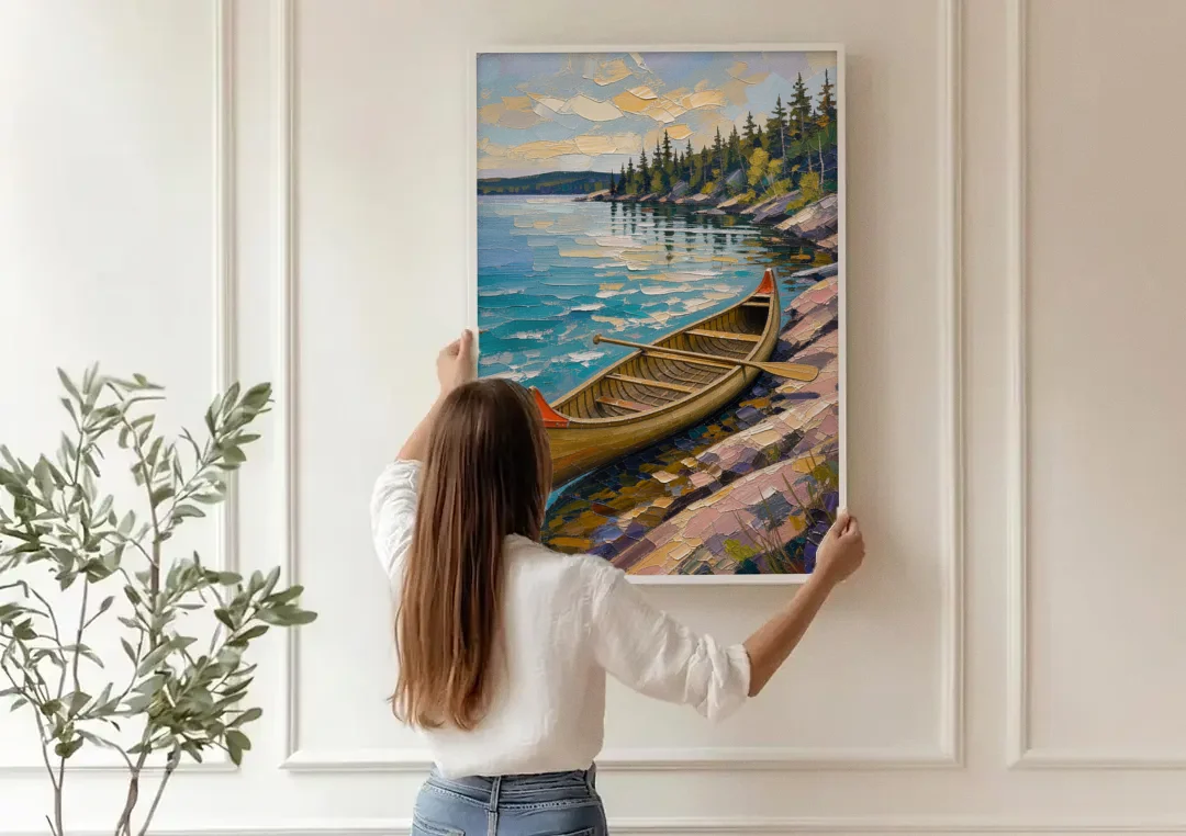 Outdoorsy Wall Art of a Lakeside Canoe canvas wall art being hung on a paneled wall