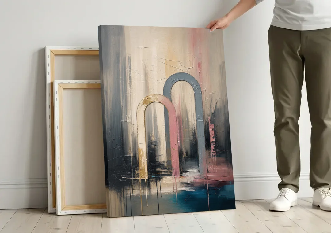 Overlapping Ivory and Slate Arches canvas wall art leaning against a wall next to blank canvases