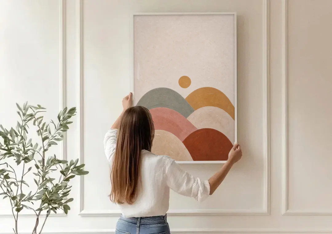 Overlapping Scalloped Hills Under a Small Sun canvas wall art being hung on a paneled wall