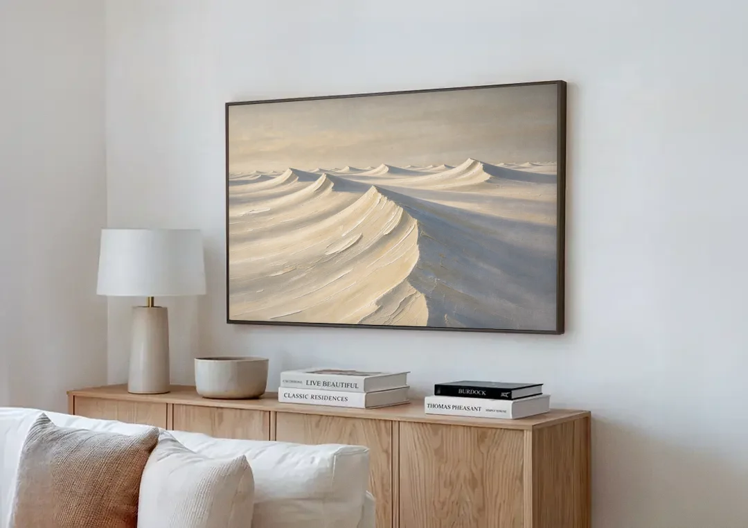 Oversized Neutral Wall Art of Curling Snow Drifts canvas wall art above a wooden sideboard next to a sofa