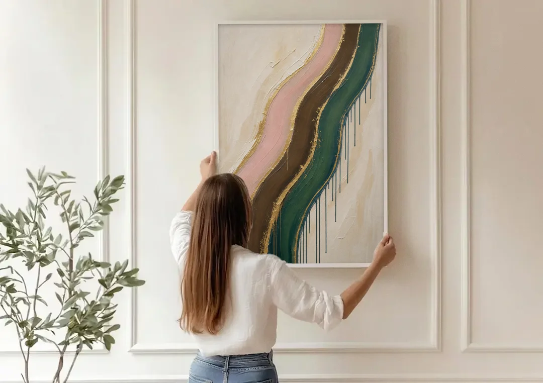 Oversized Textured Gilded Ribbon Drift canvas wall art being hung on a paneled wall