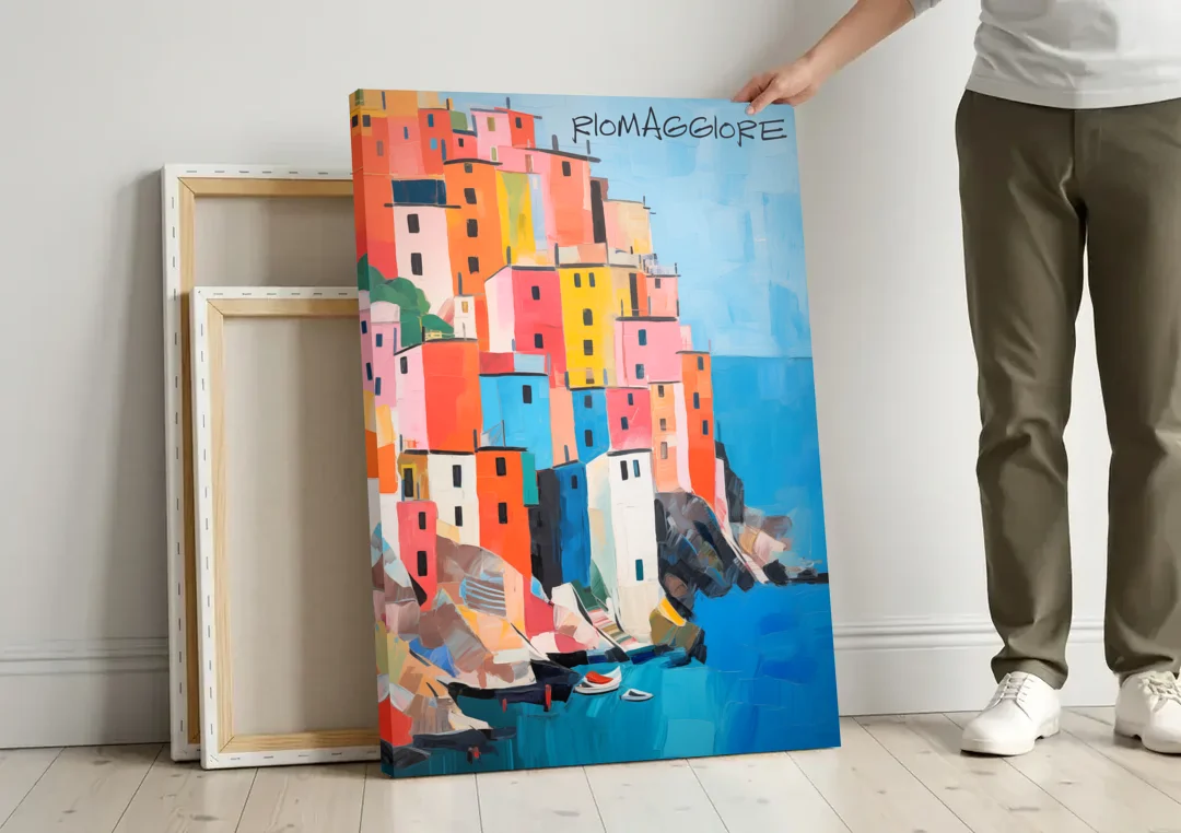 Palette Knife Painting of Riomaggiore canvas wall art leaning against a wall next to blank canvases
