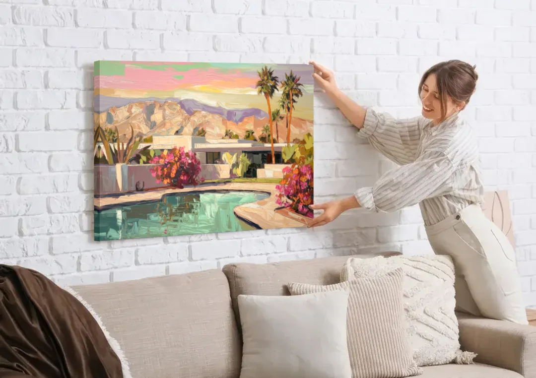 Palm Springs Sunlit Landscape canvas wall art being hung on a white brick wall above a sofa